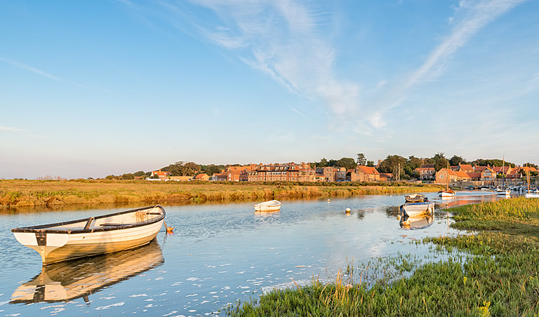 Photo on a sunny day over the salt marshes at Blakeney on the North Norfolk coast, looking towards the harbour & village